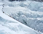 Escaladores en la cumbre del Monte Everest con banderas