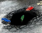 Calle Marsh en Bristol con asfalto deteriorado y múltiples baches
