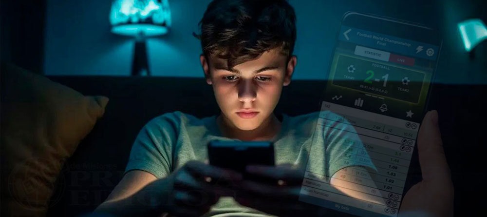 Adolescente usando un teléfono celular con pantalla de apuestas deportivas