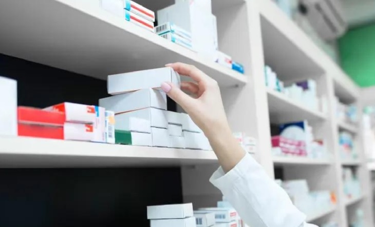 Farmacéutica atendiendo a un paciente en una farmacia
