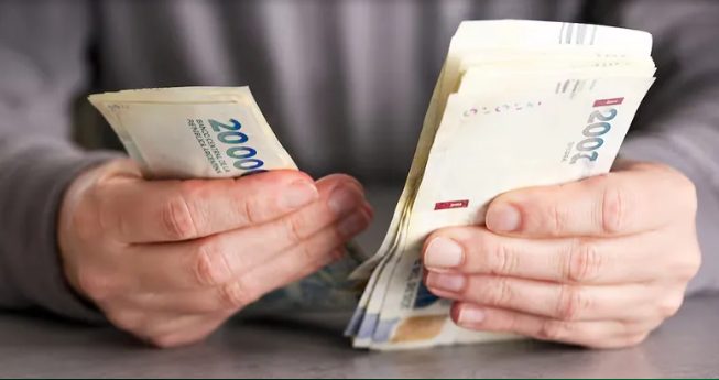 Personas trabajando en una oficina con documentos y calculadora